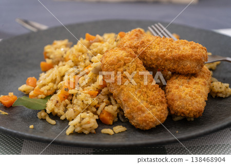 Spiced Rice with Golden Fried Fish Strips Spiced Rice with Golden Fried Fish Strips 138468904