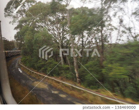 The winding curves of the forest flow past the window on the way back to Sydney—a quiet view at the end of a journey away from the mountains. The winding curves of the forest flow past the window on the way back to Sydney—a quiet view at the end of a journey away from the mountains. 138469000