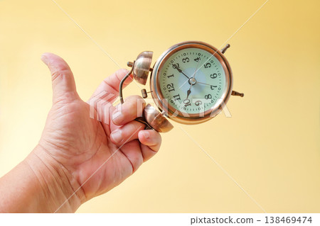 Vintage Alarm clock in hand,Time in hand concept. 138469474