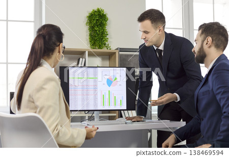 Business team meeting on strategy and data analytics, monitor with infographics Business team meeting on strategy and data analytics, monitor with infographics 138469594