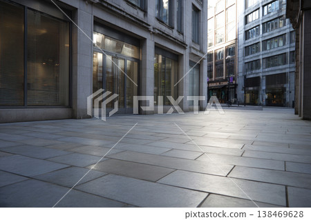 Open plaza features smooth paving stones with glass buildings reflecting sunlight. The area is quiet with no people. It is a bright day, showcasing urban architecture and greenery Open plaza features smooth paving stones with glass buildings reflecting sunlight. The area is quiet with no people. It is a bright day, showcasing urban architecture and greenery 138469628
