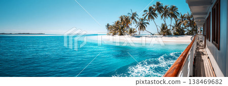 A large passenger cruise ship moves through clear blue water. The scene shows a sunny day with fluffy clouds in the sky and a tropical backdrop near the shore, banner A large passenger cruise ship moves through clear blue water. The scene shows a sunny day with fluffy clouds in the sky and a tropical backdrop near the shore, banner 138469682