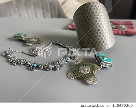 Jewelry pieces with turquoise accents on a table in a simple indoor setting during the day Jewelry pieces with turquoise accents on a table in a simple indoor setting during the day 138470366