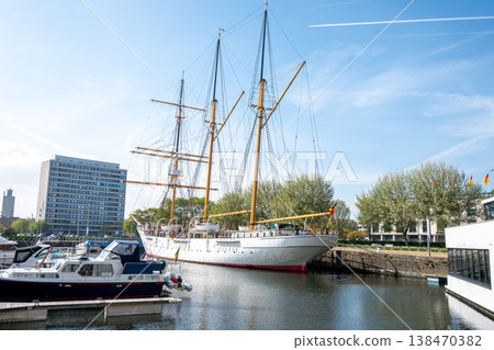 Beautiful big ild ship in Belgium, Ostend. Port with yachts, ships, sea water, modern buildings. Water transport in the harbor.  138470382