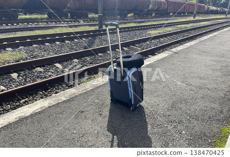 a suitcase on the rail station a suitcase on the rail station 138470425