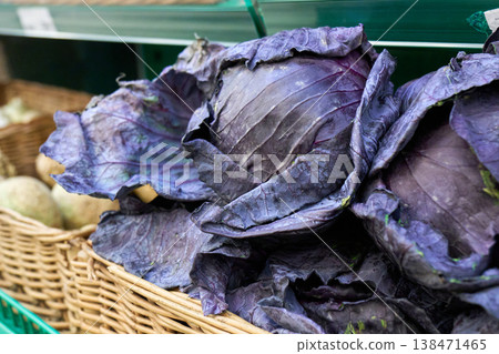 Fresh purple cabbage is arranged in a woven basket at a market stand Fresh purple cabbage is arranged in a woven basket at a market stand 138471465