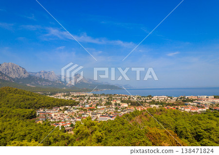 View of Kemer town on a coast of the Mediterranean sea in Antalya province, Turkey. Turkish Riviera. View from a mountain View of Kemer town on a coast of the Mediterranean sea in Antalya province, Turkey. Turkish Riviera. View from a mountain 138471824