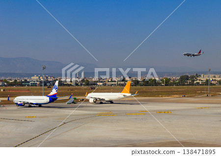 Busy airport with airplanes and service vehicles in Antalya, Turkey Busy airport with airplanes and service vehicles in Antalya, Turkey 138471895