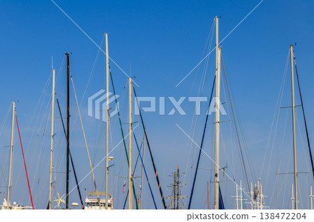 Masts of sailboats against clear blue sky 138472204