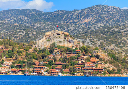 View of ancient Lycian town Simena with fortress on a mount on the coast of the Mediterranean sea in Antalya Province, Turkey View of ancient Lycian town Simena with fortress on a mount on the coast of the Mediterranean sea in Antalya Province, Turkey 138472406