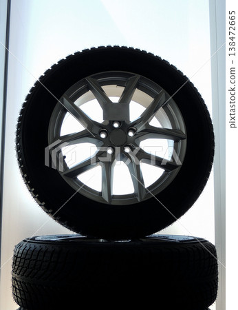 Rack of assembled car wheels with new tires and alloy discs isolated Rack of assembled car wheels with new tires and alloy discs isolated 138472665
