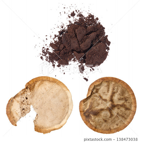 A pile of ground coffee and two used paper coffee filters with stains on an isolated background A pile of ground coffee and two used paper coffee filters with stains on an isolated background 138473038