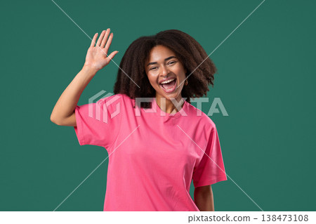 Friendly African Pretty Woman Waving Hand - Hello, Hi. Greetings. Green Studio 138473108