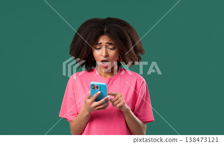 Disappointed woman with Smartphone on green studio. Internet, shock news Disappointed woman with Smartphone on green studio. Internet, shock news 138473121