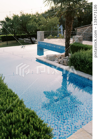 Sophisticated Tropical Oasis Featuring Mosaic Tiles And Tranquil Surroundings Sophisticated Tropical Oasis Featuring Mosaic Tiles And Tranquil Surroundings 138473186