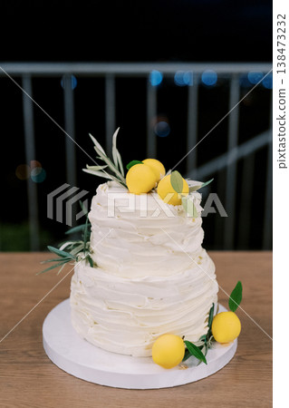Photograph Of Detailed Icing On Tiered Cake With Herbs And Lemons Surrounding Photograph Of Detailed Icing On Tiered Cake With Herbs And Lemons Surrounding 138473232