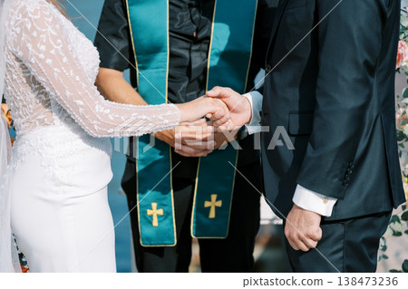 Bride And Groom Unite In Vows And Rings Within Reverent Church Setting 138473236