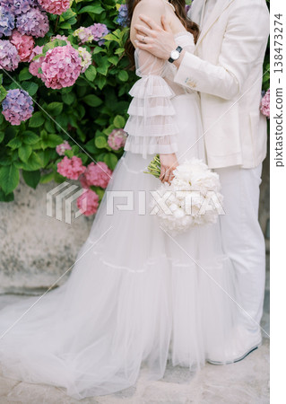 Portrait Capturing Bride And Partner Against Lively Hydrangea Floral Background Portrait Capturing Bride And Partner Against Lively Hydrangea Floral Background 138473274