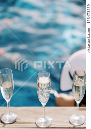 Refined Celebration Featuring Champagne Glasses Aboard Yacht Overlooking Sea Refined Celebration Featuring Champagne Glasses Aboard Yacht Overlooking Sea 138473289