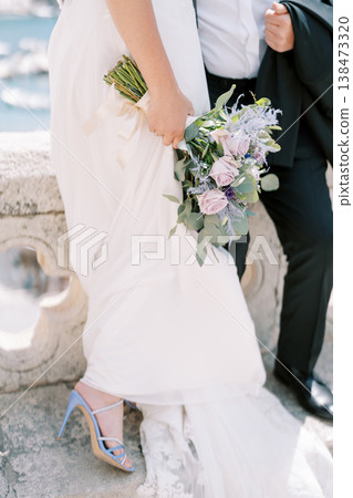Beautiful Engagement Moment Beside Ocean With Elegant Dress And Vibrant Heels 138473320