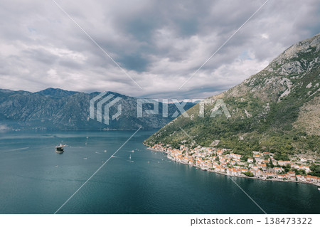 Serene Coastal Hamlet With Colorful Houses And Mountain Views 138473322