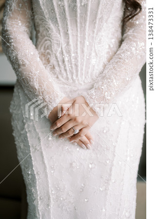Quiet Bride In Detailed Lace Attire With Clasped Hands Gracefully Held 138473331