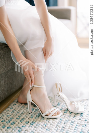 Intimate Indoor Moment As Bride Secures Her Delicate Lace Gown Details Intimate Indoor Moment As Bride Secures Her Delicate Lace Gown Details 138473352