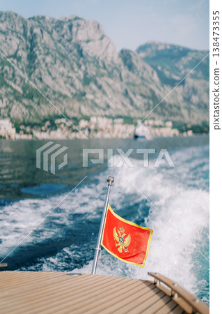 Luxurious Yacht Displaying Montenegrin Flag Amid Coastal Scenery 138473355