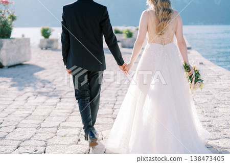 Romantic Wedding Scene With Lovers Walking Along Peaceful Seafront Promenade Romantic Wedding Scene With Lovers Walking Along Peaceful Seafront Promenade 138473405