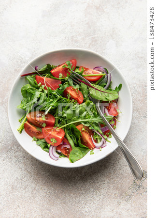 Fresh green salad with tomatoes and red onion Fresh green salad with tomatoes and red onion 138473428