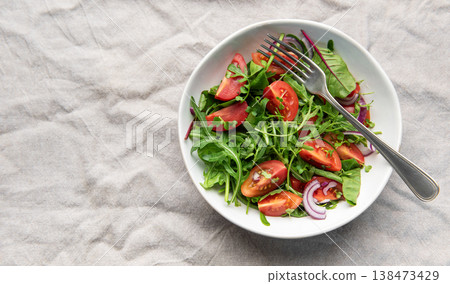 Fresh garden salad with tomatoes, arugula, and onion Fresh garden salad with tomatoes, arugula, and onion 138473429