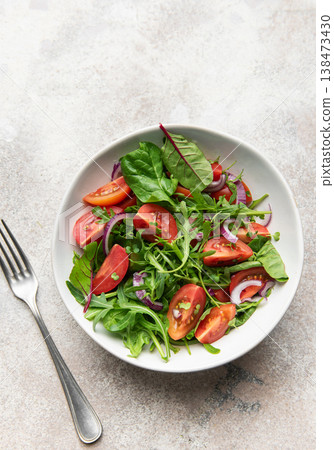 Fresh green salad with tomatoes and red onion Fresh green salad with tomatoes and red onion 138473430