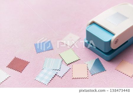 Punching decorative paper shapes for creative scrapbooking craft Punching decorative paper shapes for creative scrapbooking craft 138473448