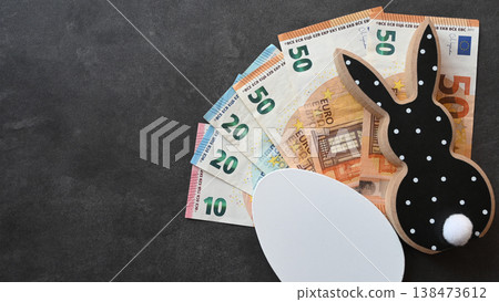 Black and white wood rabbit and egg with cash euro money for easter celebration on the stone background. Shopping of Easter holidays. Space for text. 138473612