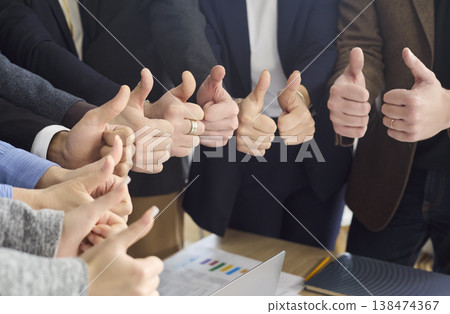 Successful business team with many thumbs up at office meeting, unity concept Successful business team with many thumbs up at office meeting, unity concept 138474367