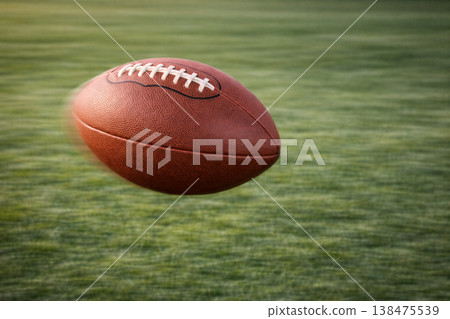 Leather Football Flying Over Green Field Leather Football Flying Over Green Field 138475539