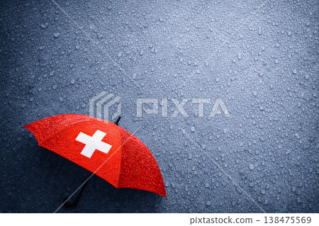 Red Umbrella With White Cross On Rainy Surface Red Umbrella With White Cross On Rainy Surface 138475569