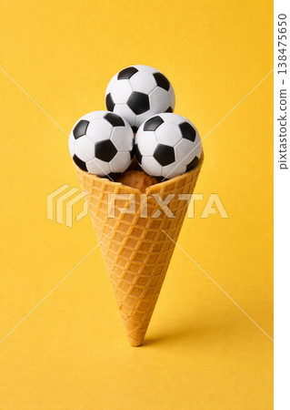 Playful soccer balls in a waffle cone 138475650