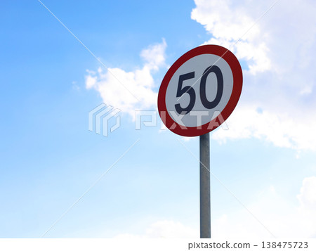 Speed Limit Sign Against Blue Sky Speed Limit Sign Against Blue Sky 138475723