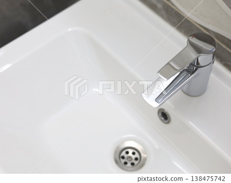 Modern bathroom sink with metal faucet Modern bathroom sink with metal faucet 138475742