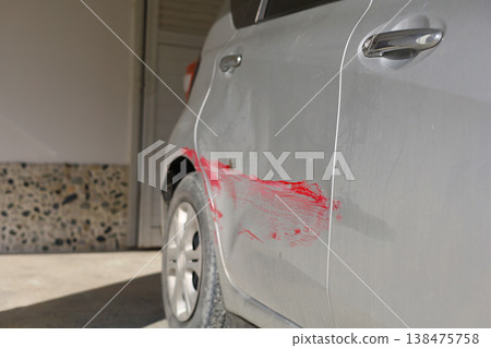 Red Paint Scrape on Silver Car Door 138475758