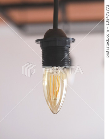 Warm Vintage Hanging Light Bulb Close Up Warm Vintage Hanging Light Bulb Close Up 138475772