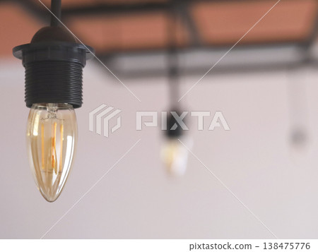 Warm Hanging Filament Bulbs Over Blurred Background 138475776