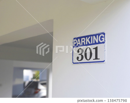 Blue Parking Sign On Interior Wall Blue Parking Sign On Interior Wall 138475798