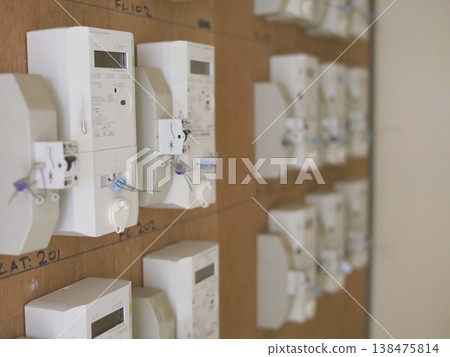 Rows of Electricity Meters on Wooden Panel 138475814