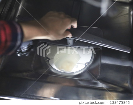 Hands Inspecting Dishwasher Interior For Maintenance Hands Inspecting Dishwasher Interior For Maintenance 138475845