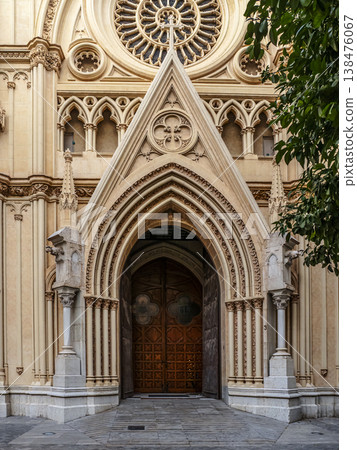 Entrance of the Sacred Heart Church With Ornate Stone Arch and Wooden Doors Under Rose Window Facade, Malaga 138476067