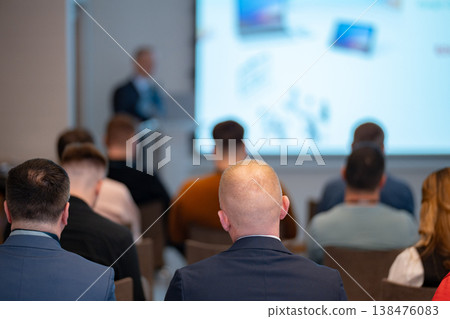 Blurred image of a business speaker presenting to an audience 138476083