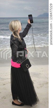 Woman taking selfie on the beach Woman taking selfie on the beach 138477229