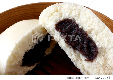 Sesame paste buns in a steamer basket against a white background Sesame paste buns in a steamer basket against a white background 138477731